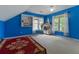 Spacious bedroom with blue walls, two windows, and neutral carpet flooring at 3500 Stillwood Dr, Snellville, GA 30039