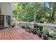 Back deck covered with potted plants and shade trees at 3500 Stillwood Dr, Snellville, GA 30039