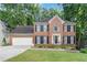 Charming two-story brick home with a well-manicured lawn and attached two-car garage at 3500 Stillwood Dr, Snellville, GA 30039