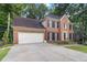 Well maintained two-story brick home with black shutters and an attached two-car garage at 3500 Stillwood Dr, Snellville, GA 30039