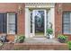 Inviting front entrance with a decorative glass door, sidelights, and classic brick surround at 3500 Stillwood Dr, Snellville, GA 30039