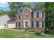 Classic brick home featuring a manicured lawn and symmetrical design with beautiful curb appeal at 3500 Stillwood Dr, Snellville, GA 30039