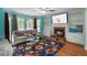 Cozy living room featuring a fireplace, built-in shelves, and ample natural light from large windows at 3500 Stillwood Dr, Snellville, GA 30039