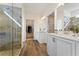 Modern bathroom with a glass enclosed shower, dual sinks, and a walk-in closet at 49 Masters Dr, Villa Rica, GA 30180