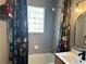 Clean bathroom with tile, walk-in shower, glass block window and stylish shower curtain at 1078 Piedmont Ne Ave # 206, Atlanta, GA 30309