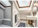 Modern bathroom with skylight, gray tiled shower, and sleek fixtures at 1078 Piedmont Ne Ave # 206, Atlanta, GA 30309
