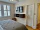 Bright bedroom with shuttered windows, modern floating console, and hardwood floors at 1078 Piedmont Ne Ave # 206, Atlanta, GA 30309