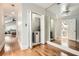 Hallway with hardwood floors, laundry closet, and mirrored sliding closet doors at 1078 Piedmont Ne Ave # 206, Atlanta, GA 30309