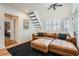 Inviting living room with wood floors, leather sectional, and staircase to the upper level at 1078 Piedmont Ne Ave # 206, Atlanta, GA 30309