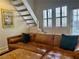 Comfortable living room with a brown leather sofa and staircase at 1078 Piedmont Ne Ave # 206, Atlanta, GA 30309