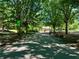 Tree-lined walking path in Piedmont Park with benches and classic lampposts at 1078 Piedmont Ne Ave # 206, Atlanta, GA 30309