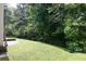 Well-maintained backyard with lush lawn and mature trees providing shade and privacy at 1382 Koble Mill Ln, Riverdale, GA 30296