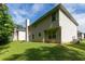 View of the home's backyard, showcasing the well-maintained lawn and neutral siding at 1382 Koble Mill Ln, Riverdale, GA 30296