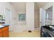 Bright bathroom with a soaking tub, separate shower, and neutral tile at 1382 Koble Mill Ln, Riverdale, GA 30296