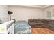 Bedroom with bed and couch, featuring neutral walls and minimal decor at 1382 Koble Mill Ln, Riverdale, GA 30296