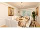 Elegant dining room featuring a table set for eight, crown molding, and plant accents at 1382 Koble Mill Ln, Riverdale, GA 30296