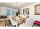 Formal dining room featuring a long table, white chairs, and natural light at 1382 Koble Mill Ln, Riverdale, GA 30296