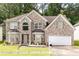 Charming two-story brick home with an attached two-car garage and well-maintained lawn at 1382 Koble Mill Ln, Riverdale, GA 30296
