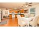 Charming kitchen with wood cabinets and white appliances adjacent to the dining area, filled with natural light at 1382 Koble Mill Ln, Riverdale, GA 30296