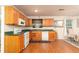 Traditional kitchen with wooden cabinets, green countertops, and white appliances, enhanced by natural light at 1382 Koble Mill Ln, Riverdale, GA 30296