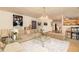 Open-concept living room with stylish decor, comfortable seating, and adjacent dining area at 1382 Koble Mill Ln, Riverdale, GA 30296