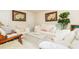 Bright living room with white furniture, plants, and tasteful decor at 1382 Koble Mill Ln, Riverdale, GA 30296