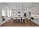 Modern kitchen with stainless steel appliances, white cabinets, an island, and an open plan dining area at 1572 Wicker Wood Se Pl, Smyrna, GA 30080