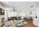 Bright living room with fireplace, modern furnishings, and an open floor plan connecting to the kitchen at 1572 Wicker Wood Se Pl, Smyrna, GA 30080