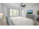 Spacious main bedroom with a ceiling fan, dresser, and a view from the three light-filled windows at 1572 Wicker Wood Se Pl, Smyrna, GA 30080