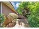 Relaxing backyard with a wooden deck surrounded by mature trees and greenery at 5267 Sheppard Ln, Stone Mountain, GA 30083