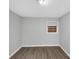 This bedroom has laminate wood flooring and a window with blinds at 5267 Sheppard Ln, Stone Mountain, GA 30083