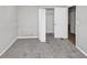 This bedroom is carpeted and has a large closet and white trim at 5267 Sheppard Ln, Stone Mountain, GA 30083