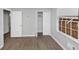 This bedroom has laminate wood flooring, a window with blinds, and a closet at 5267 Sheppard Ln, Stone Mountain, GA 30083