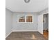 This bedroom has laminate wood flooring, a window with blinds, and white trim at 5267 Sheppard Ln, Stone Mountain, GA 30083
