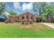 Charming brick home featuring a covered front porch and carport, complemented by a lush green lawn and mature trees at 5267 Sheppard Ln, Stone Mountain, GA 30083