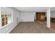 Renovated living room features neutral walls and new flooring, with a window providing natural light at 5267 Sheppard Ln, Stone Mountain, GA 30083