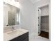 Bathroom features white vanity with gray cabinets, walk-in shower, and view to closet at 912 Sunny Meadows Ln, Marietta, GA 30062