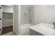 Bathroom with neutral finishes featuring marble tiled walls and sink with shower at 912 Sunny Meadows Ln, Marietta, GA 30062