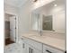 Bright bathroom features a stylish vanity, a large mirror, and a door leading to a closet at 912 Sunny Meadows Ln, Marietta, GA 30062