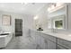Elegant bathroom featuring dual sinks, marble floors, and soaking tub at 912 Sunny Meadows Ln, Marietta, GA 30062
