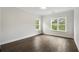 Bright, airy bedroom with hardwood floors and a view of trees at 912 Sunny Meadows Ln, Marietta, GA 30062