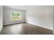 Spacious bedroom with hardwood floors, a large window, and neutral paint at 912 Sunny Meadows Ln, Marietta, GA 30062