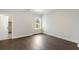 Bedroom featuring hardwood flooring, a window with backyard view, and ample space at 912 Sunny Meadows Ln, Marietta, GA 30062
