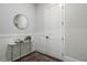 Elegant entryway features wainscoting, stylish decor, and a round mirror, creating a charming first impression at 912 Sunny Meadows Ln, Marietta, GA 30062