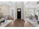Bright open foyer with hardwood floors, white walls and trim, and view to living spaces at 912 Sunny Meadows Ln, Marietta, GA 30062
