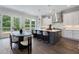 Bright kitchen features white cabinets, stainless hood, island with bar seating, and adjacent dining area at 912 Sunny Meadows Ln, Marietta, GA 30062