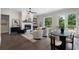 Open-concept living space with fireplace, stylish decor, and access to outdoor deck at 912 Sunny Meadows Ln, Marietta, GA 30062