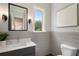 Powder room features shiplap walls, gray vanity, and decorative mirror with sconces at 912 Sunny Meadows Ln, Marietta, GA 30062