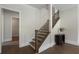 Inviting staircase with hardwood steps, black iron railings, and decorative table with vase at 912 Sunny Meadows Ln, Marietta, GA 30062