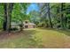 A serene backyard with a lush lawn, tall trees, and mature landscaping at 112 Valley Rd, Stockbridge, GA 30281